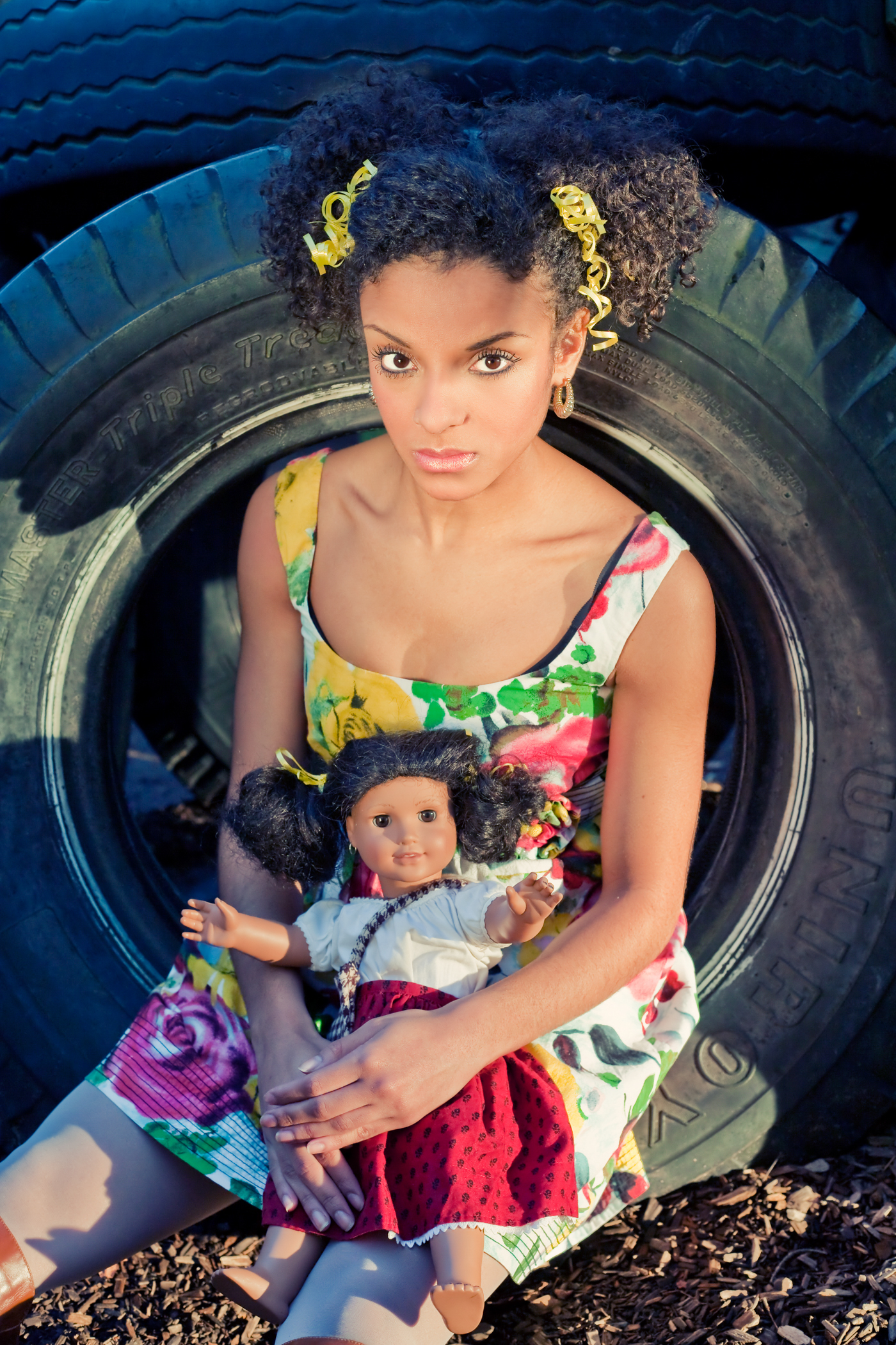 Lilith Mesidor in the Doll Collection by San Francisco artist & photographer Ella Sophie. Woman with doll in playground