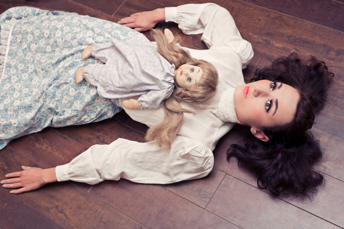 Doll Collection image by Feminist photographer Ella Sophie. Model Zoe West laying on floor with doll.