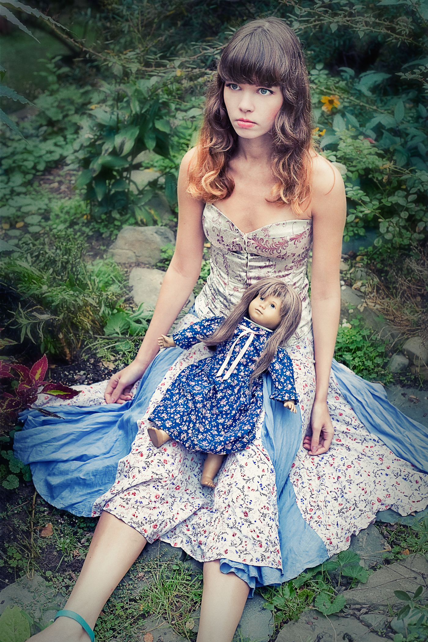 Young girl posing as doll in garden. Feminist photo series by Ella Sophie. Oakland Photographer.