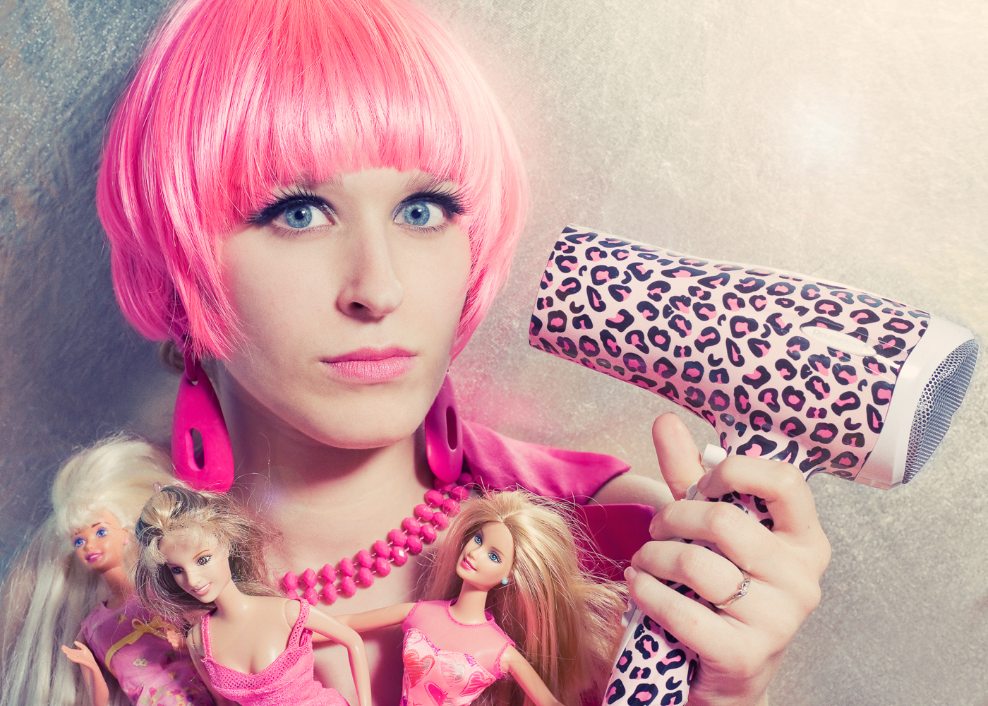 Woman shooting herself with pink hairdryer. Conceptual feminist photography by Ella Sophie. San Francisco CA