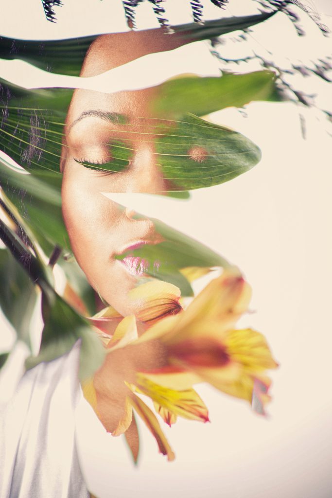 Obscured Light Series, experimental portrait photography by Ella Sophie, black woman's face with flowers and eyes closed 